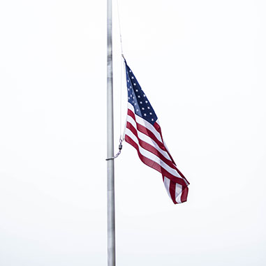 The American flag at half-mast | photo by Eastman Childs