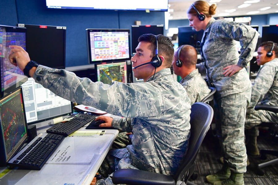 air guard group monitoring an array of radar screens