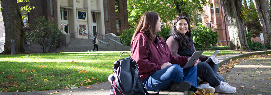 SPU students work on their laptops in Tiffany Loop on campus