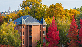 Alexander Hall in the fall with red and yellow leaves on the trees