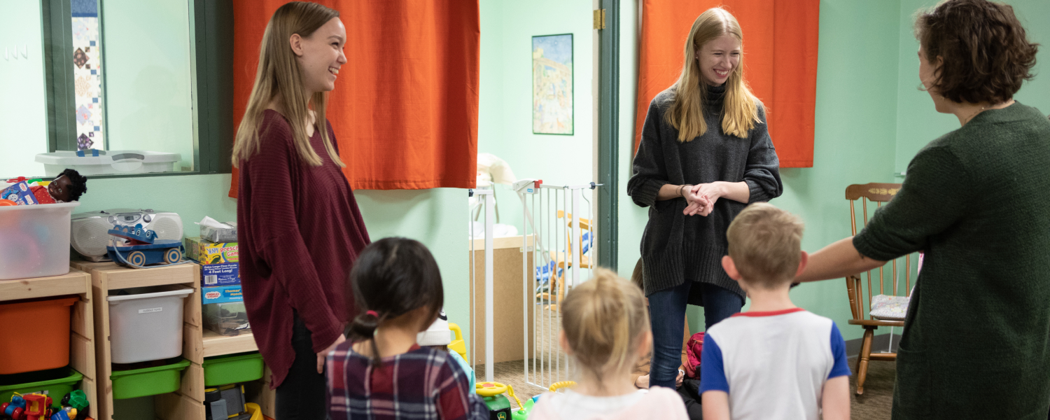 Students in the SPU's School of Education work with young children in a classroom.