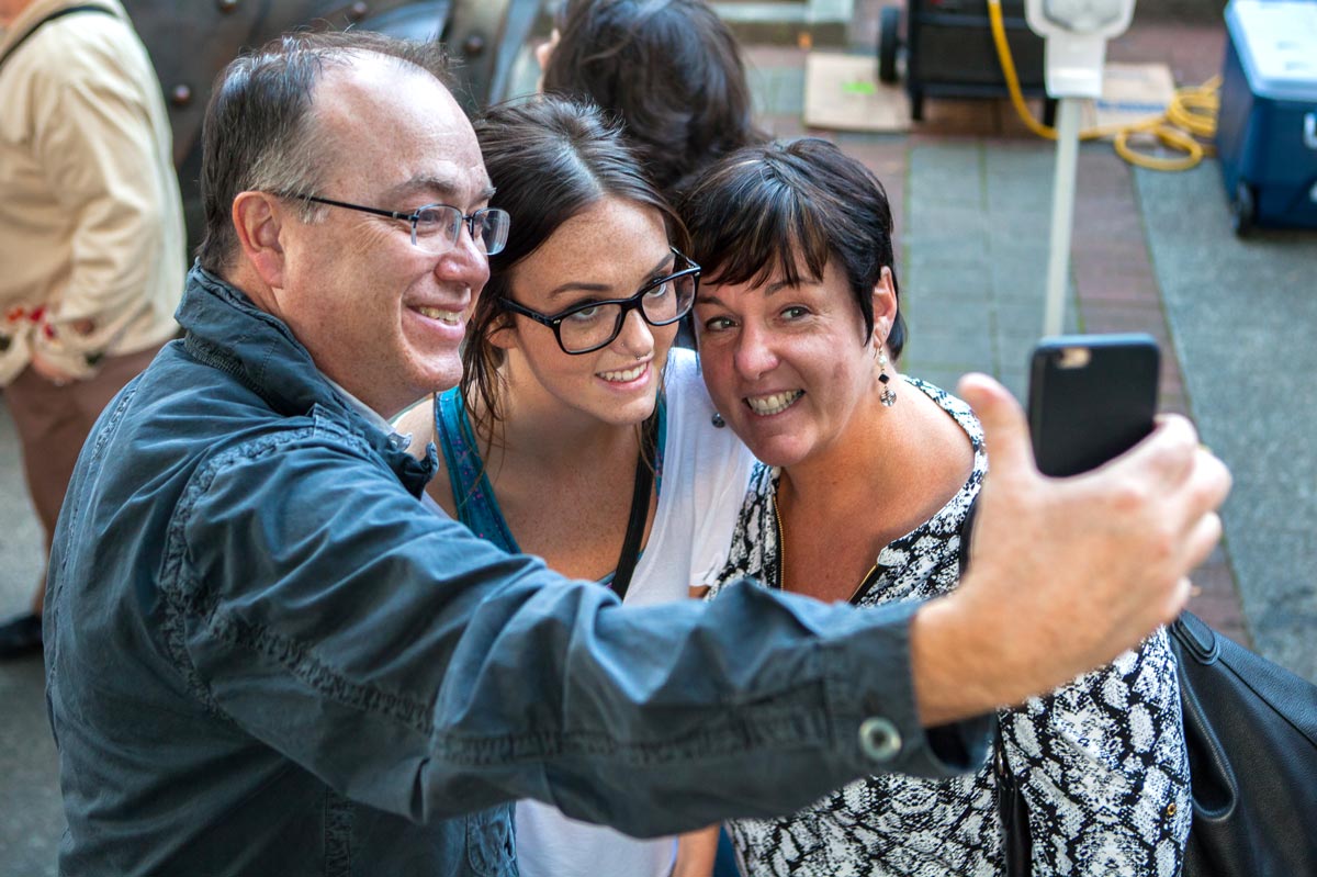 Parents taking a selfie with student