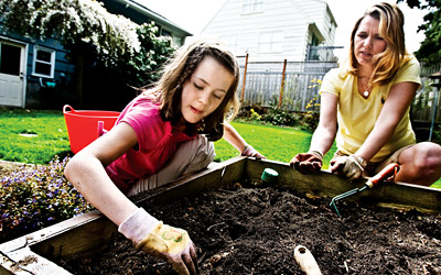 Jennifer Perrow and her daughter Allie in their garden.