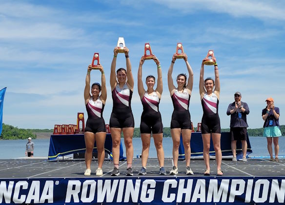 The SPU women's rowing varsity team hold up their trophies