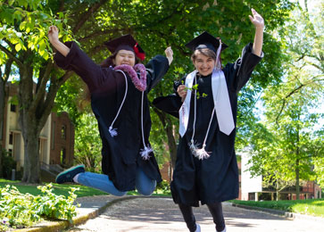 graduates jump in the air