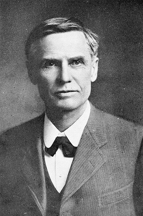 A black and white headshot of William Simon Uren