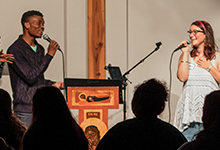 Two singers from SPU's praise and worship band perform at chapel on the road.