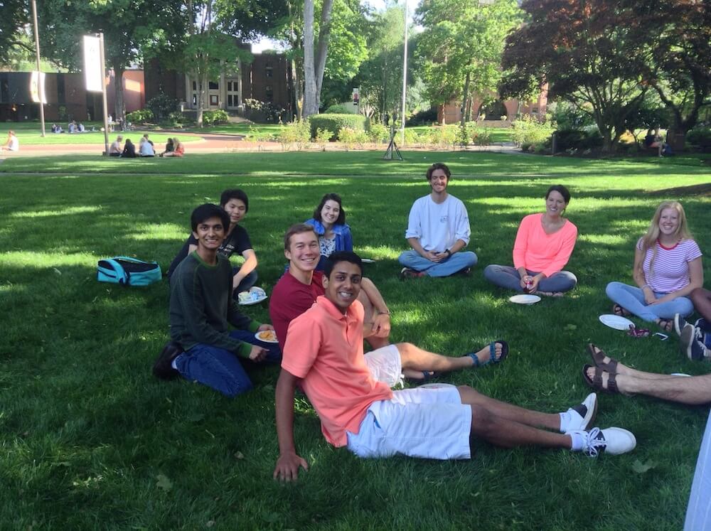 Students hanging out on the lawn with Dr. Robinson