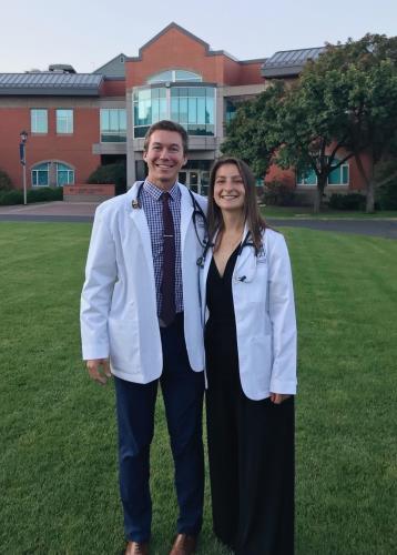 Samuel Black and Emma Reisman wearing their UW School of Medicine White Coats