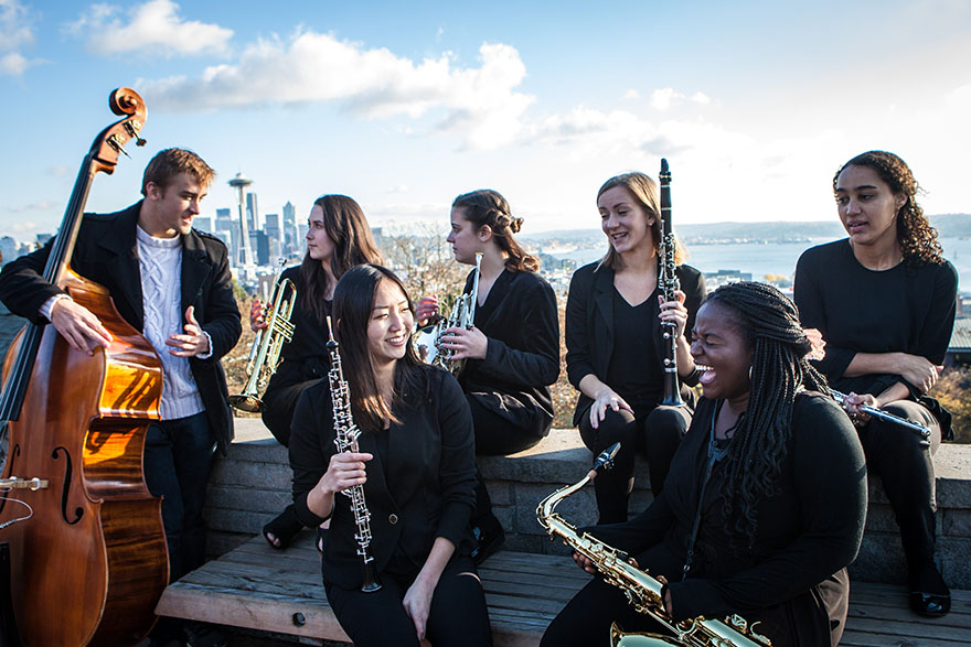 SPU musicians enjoy the weather outdoors with their instruments. The Space Needle is visible in the background