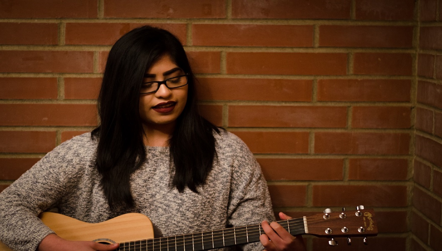 Student Ruth Rodriguez Playing the Guitar