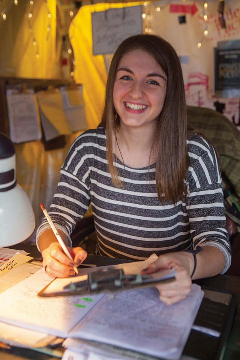 Sociology student working the desk at Tent City