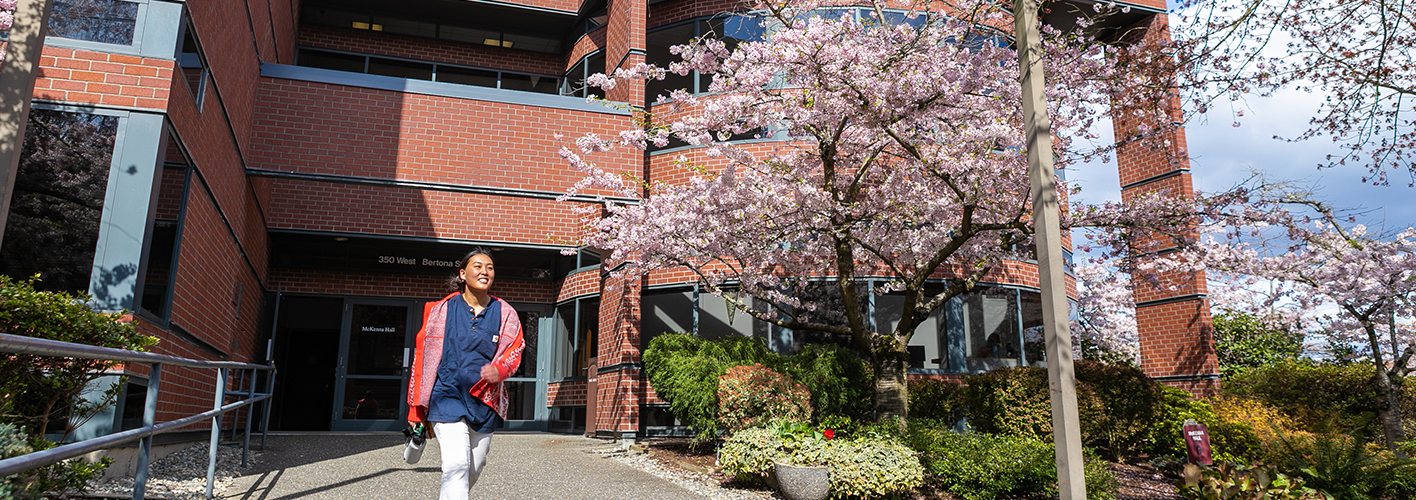 SBGE student in front of McKenna Hall in Spring