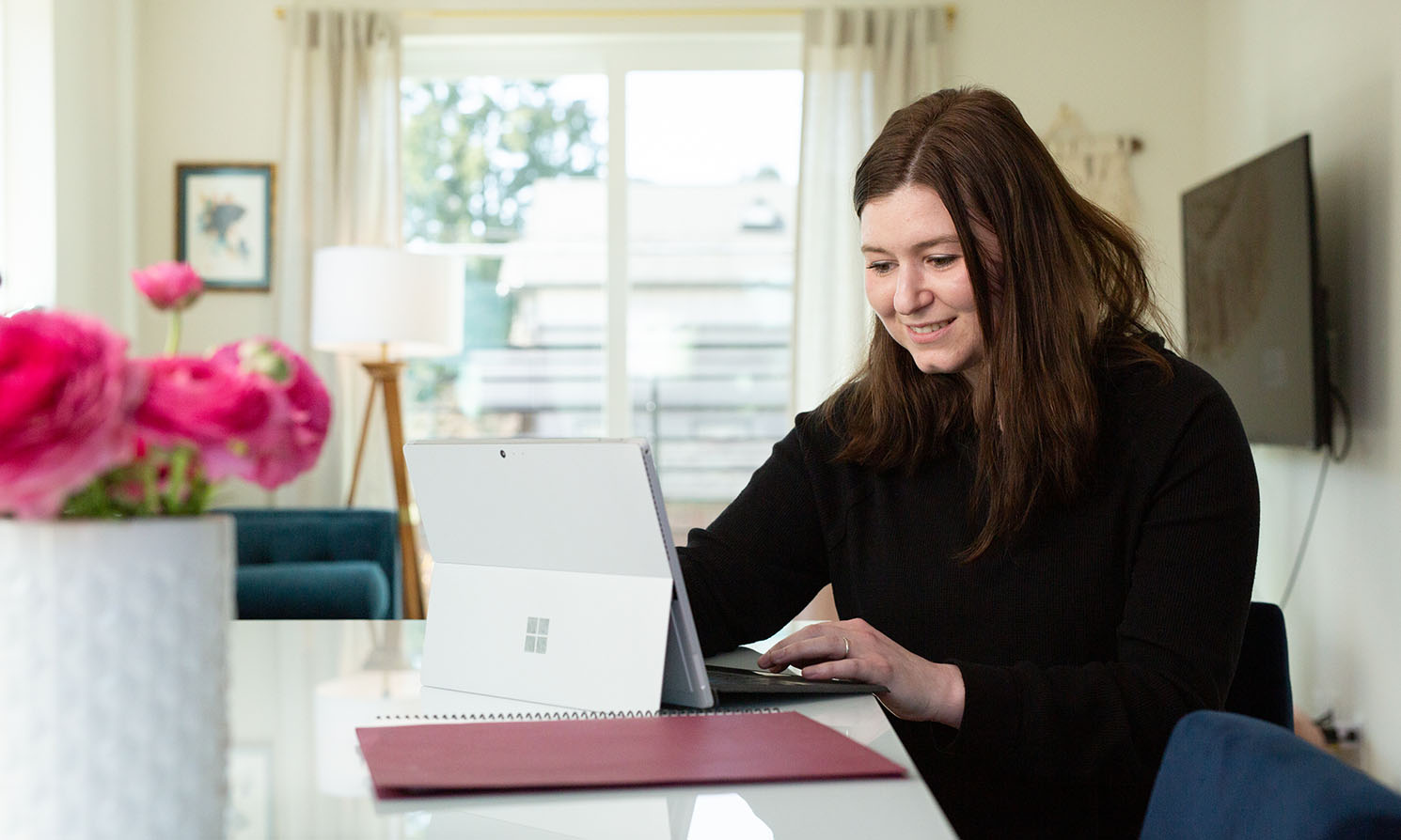 An MBA student works on her laptop at home | photo by Chris Baron