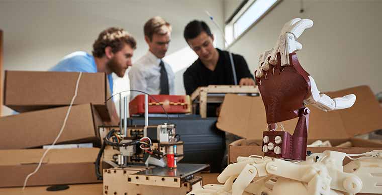 Mechanical Engineering students working on a 3-D printed prosthetic hand