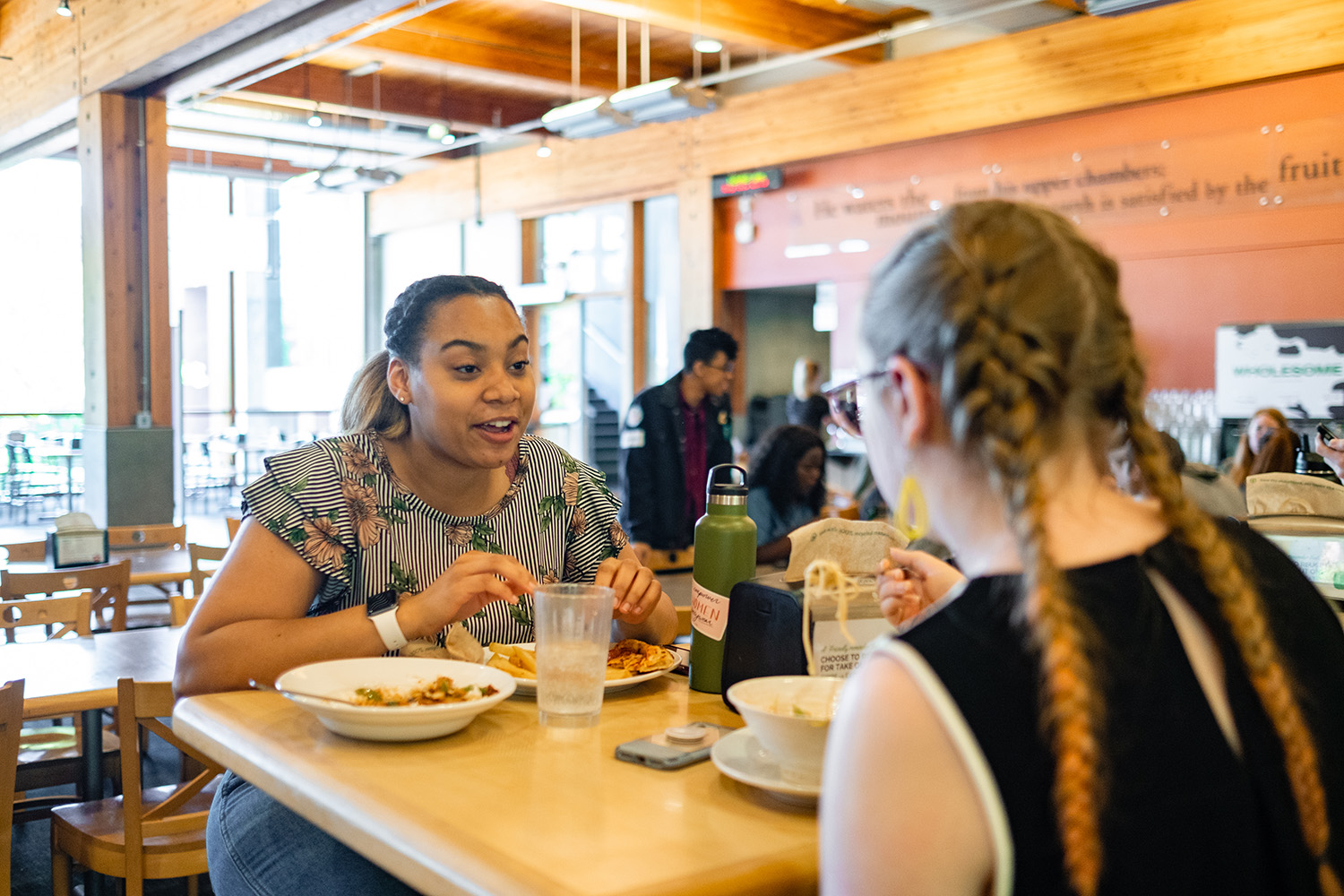 Two people eat in Gwinn Commons | photo by Chris Yang