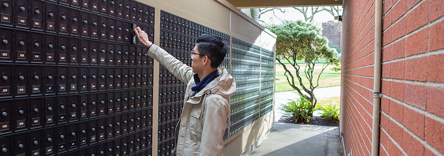 An SPU student checks his mailbox