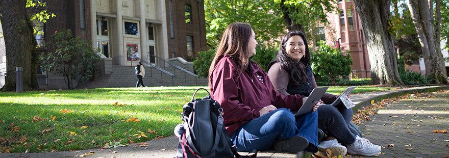 SPU students work together on laptops in Tiffany Loop