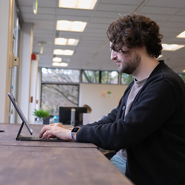 An SPU student works on their laptop