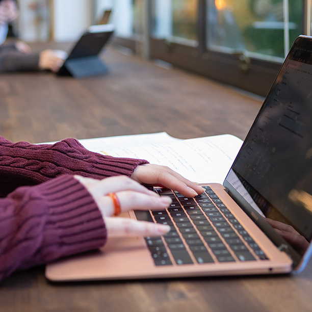 An SPU student fills out a form on their laptop