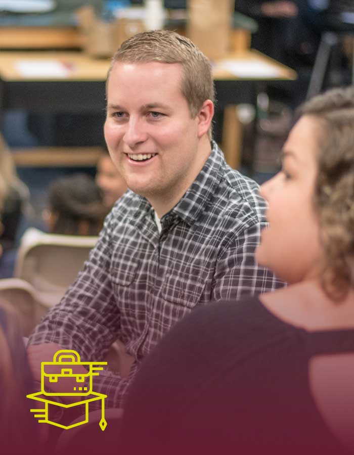 a guy smiles in class