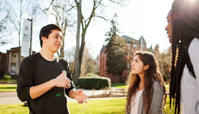 Psychology website, Students standing and talking in the Loop
