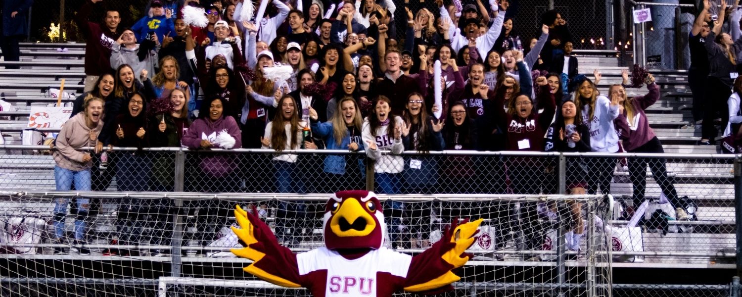 SPU mascot, Talon, leads the crowd in cheers at a Falcon soccer game.