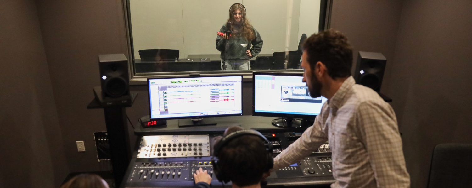 A professor and two students work together in the music studio at SPU.