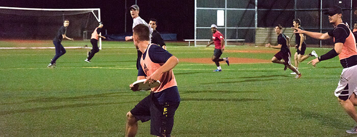 SPU students playing intramural ultimate frisbee at night