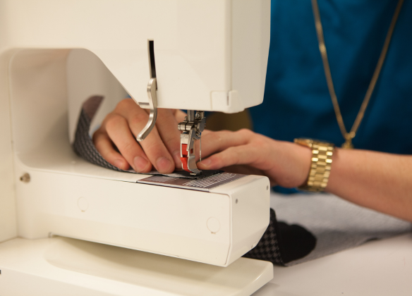 Hands at a sewing machine