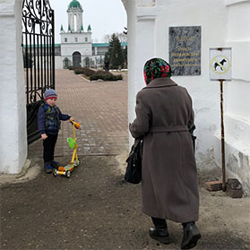 A young boy and his grandmother enter the Spasso-Yakovlevsky Monastery in Rostove, Russia