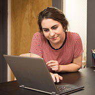 An SPU student uses the Virtual Scholarship Notebook on her laptop