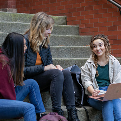SPU students study on the steps of Peterson Hall 