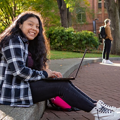 An SPU student works on her laptop while in SPU's Tiffany Loop