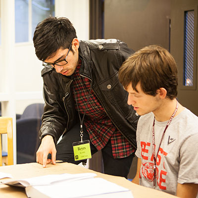 A peer tutor helps a students at one of the study tables in the Center for Student Sucess.