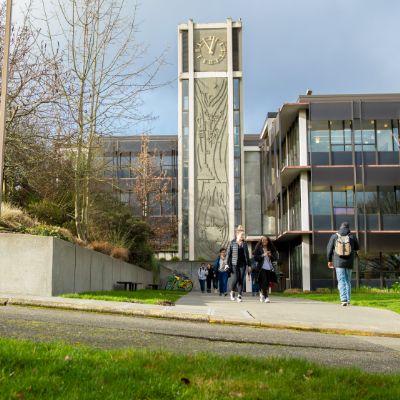 Students walk in and out of Demaray Hall on a wintery day on the Seattle Pacific University campus