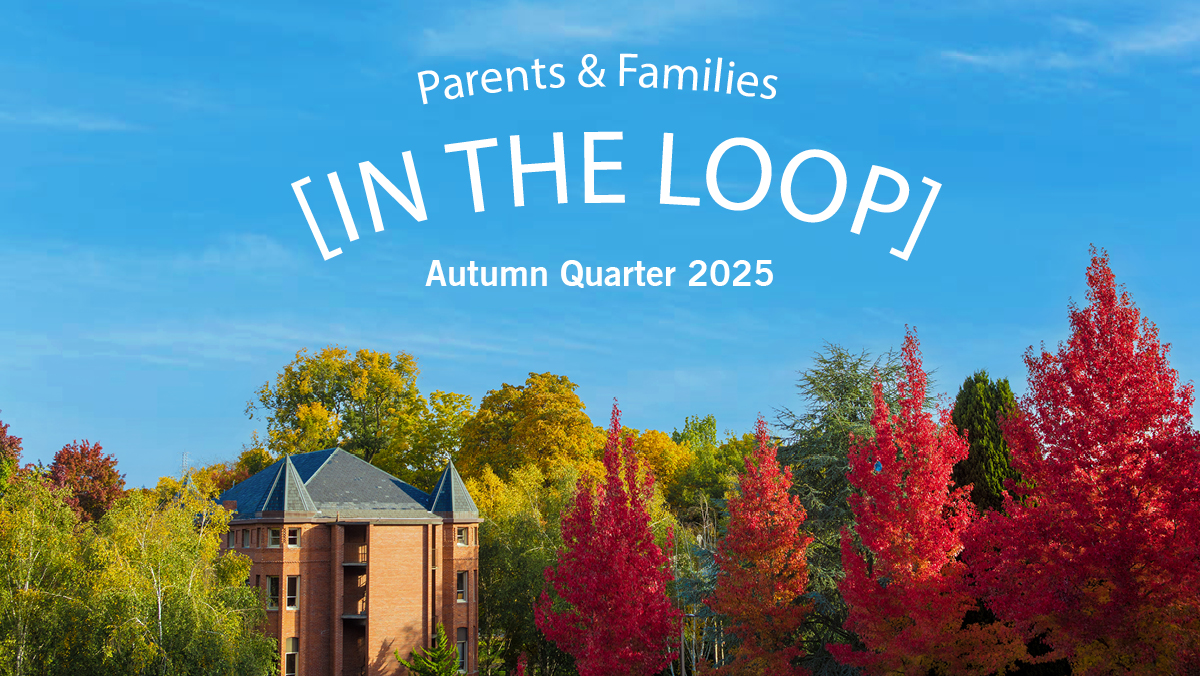 Alexander and Adelaide Hall sits in the distance under a clear blue sky and surrounded by autumn trees on the Seattle Pacific University campus