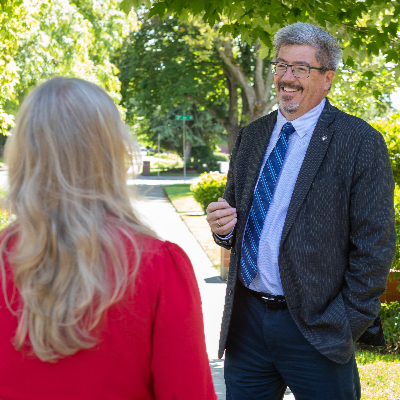 Vice President for Student Life Jeff Jordan talks to a student on the Seattle Pacific University campus