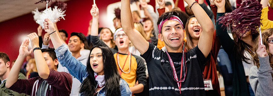 Seattle Pacific University students cheer at a volleyball game