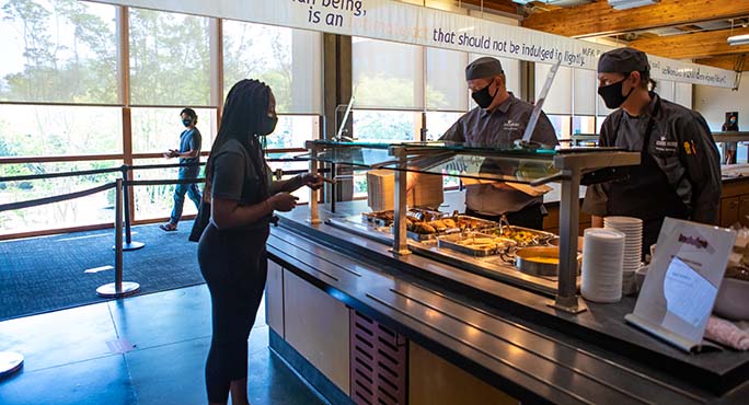 A student picks up food in Gwinn Commons