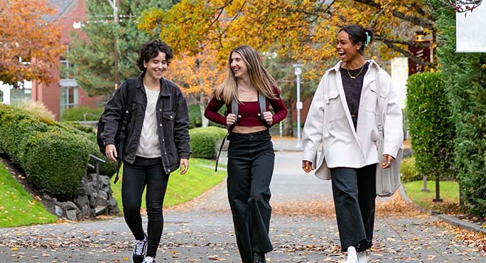 Students walk across campus on a fall afternoon