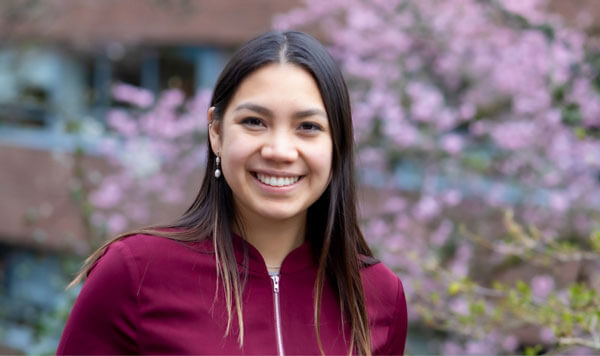 student with cherry blossoms in background