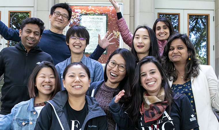 International students pose on the steps of McKinley Hall during orientation