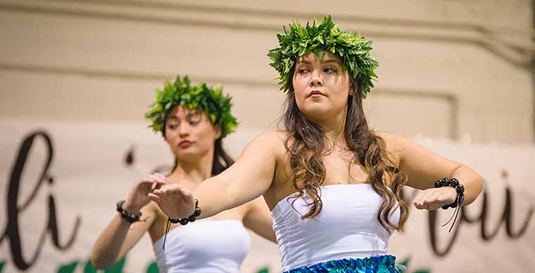 Two students dancing Hawaiian traditional dance