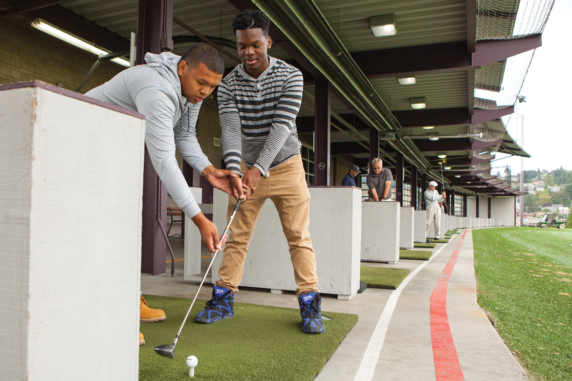 Students prepare to swing at the Interbay Golf Center