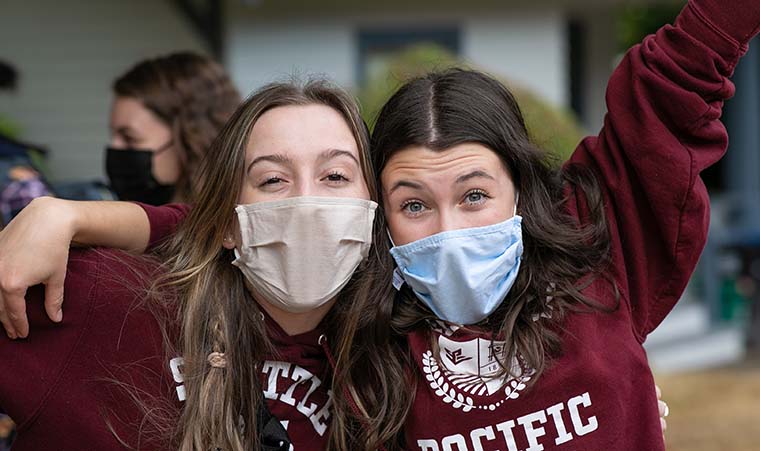 SPU students wearing masks and posing for the camera