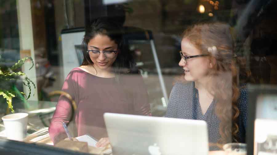 studying at cafe seen through window