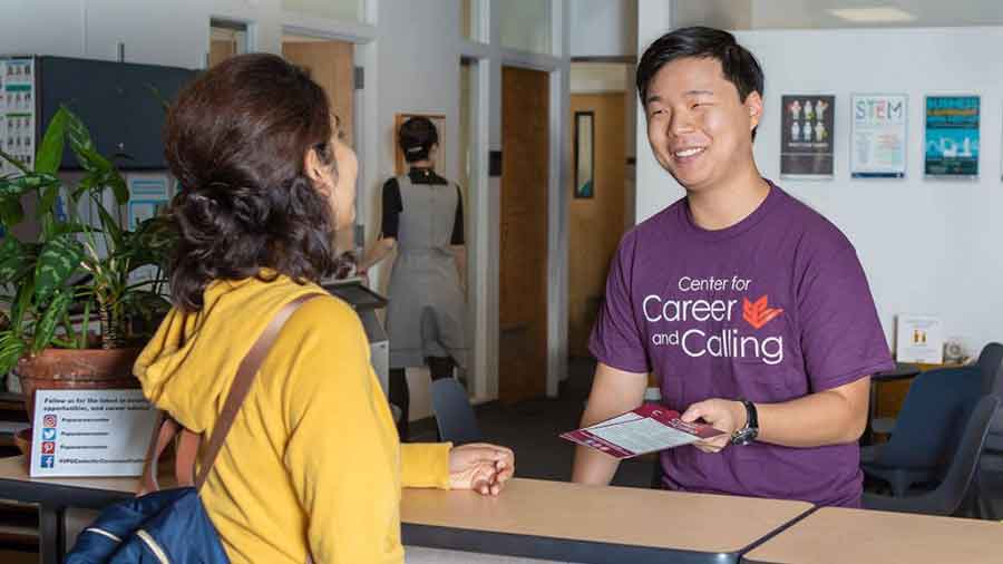 student helps another at center of career and calling