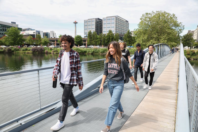 Students walk across a bridge