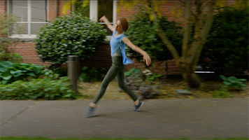 An SPU dance student performs on the sidewalk